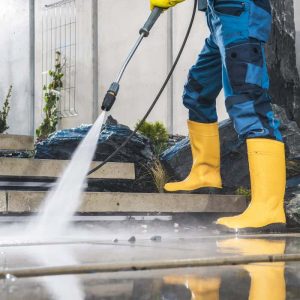Pressure Washing in yellow boots